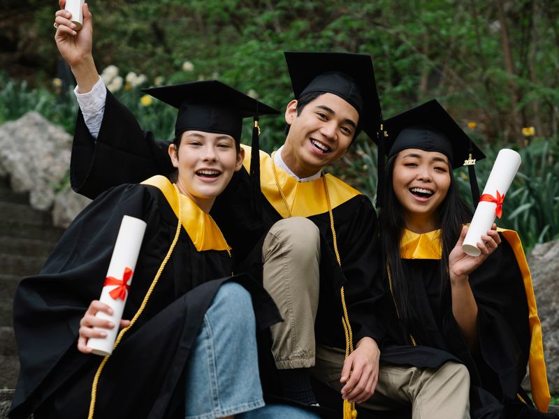 Graduates celebrating with their diplomas