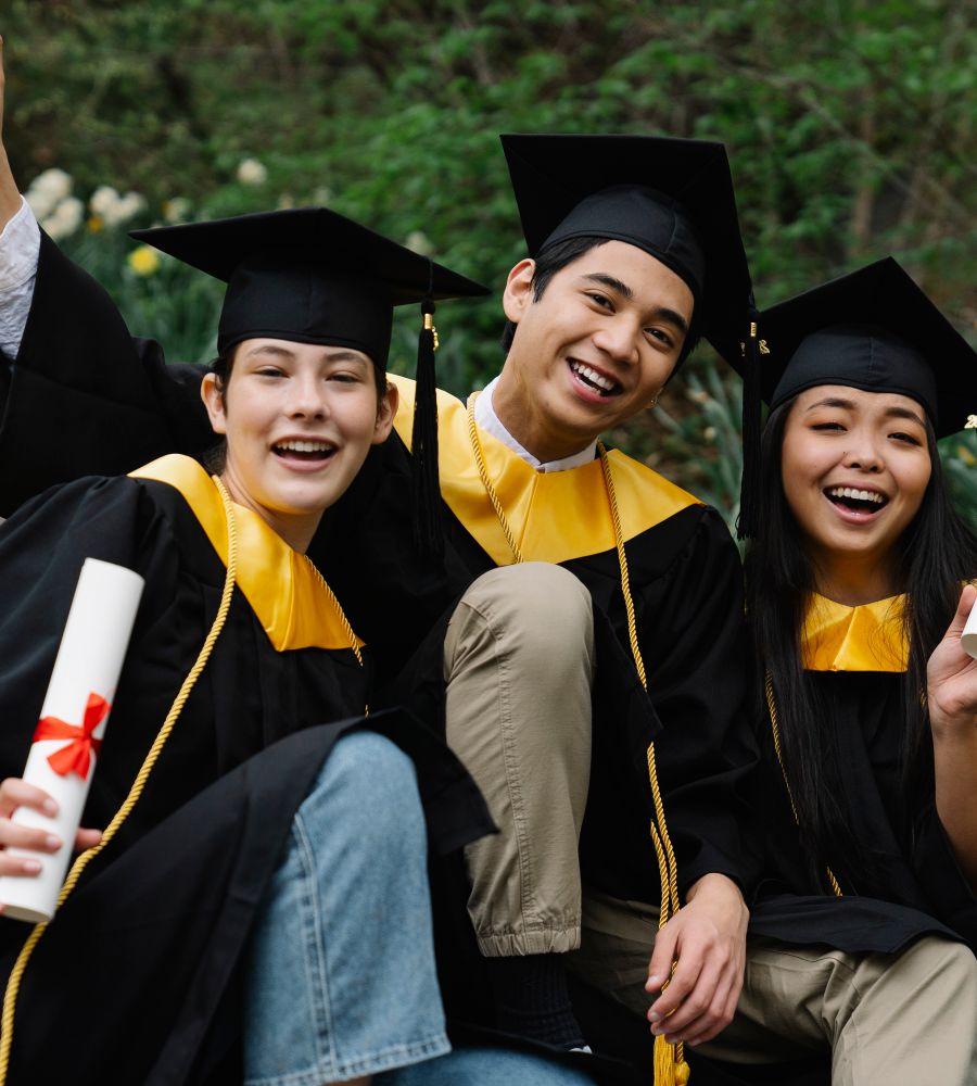 Graduates celebrating with their diplomas